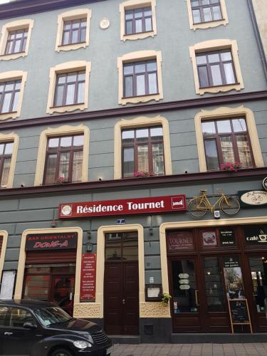 a tall blue building with aresurance turret at Résidence Tournet in Krakow