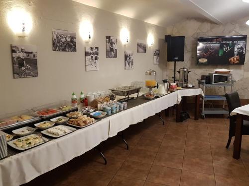 a buffet line with plates of food on it at Résidence Tournet in Kraków