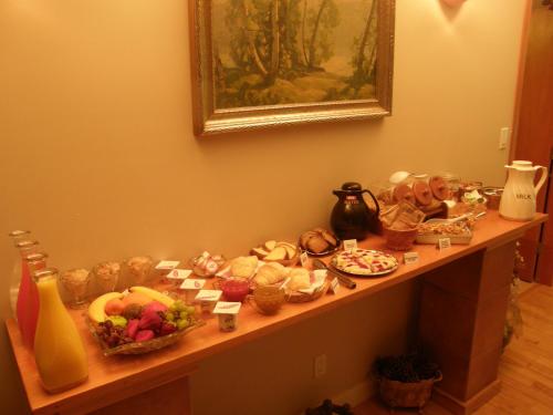 a table with many different types of food on it at Cedar Wood Lodge Bed & Breakfast Inn in Port Alberni