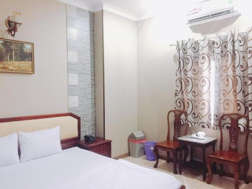 Giường trong phòng chung tại Tan Thu Do 2 Hotel 新首都2飯店