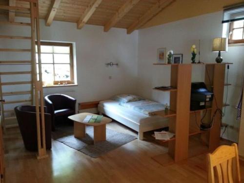 a bedroom with a bed and a desk in it at Stöckl Gaby in Rauris