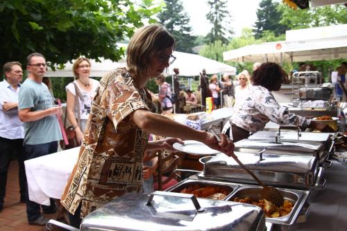 a woman preparing food at an outdoor event at Haus Mühlenbrock in Schermbeck