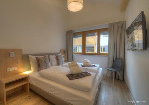 En eller flere senge i et værelse på Penthouse Kaprun by Kaprun Rentals