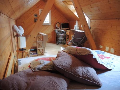 a room with a bed in a wooden attic at GITE le 70 à TURCKHEIM, 10 min Colmar in Turckheim