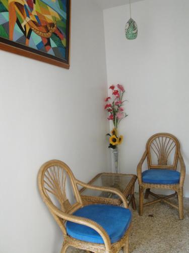 two chairs and a table with a vase of flowers at Harmony Hotel in Panglao