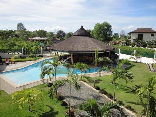 een afbeelding van een resort met een zwembad en een prieel bij Harmony Hotel in Panglao