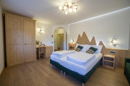 Säng eller sängar i ett rum på Hotel Bertoldi
