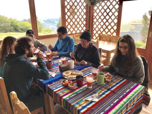 a group of people sitting at a table eating at Turismo Comunitario La Esperanza in Colta