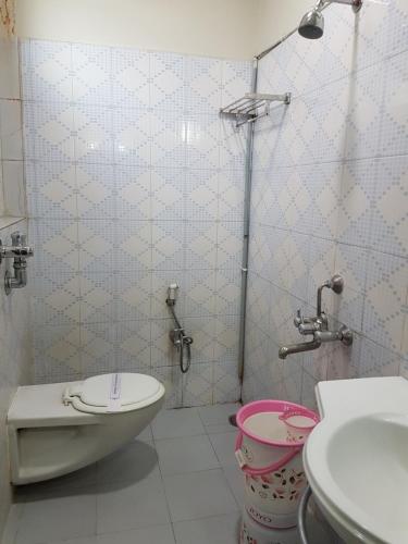 a bathroom with a toilet and a sink at Hotel Sitara Residency in Hyderabad