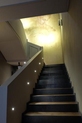 a staircase in a building with a painting on the wall at La Rocca Guest House & Spa in Montefalco