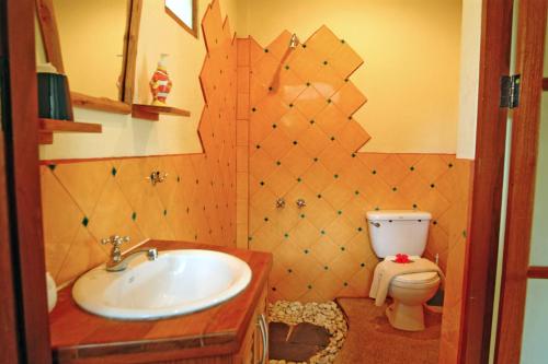 a bathroom with a sink and a toilet at Palm Garden Resort in Rawai Beach