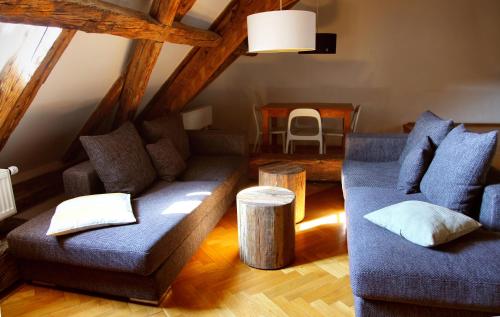 a living room with two couches and a table at Three Golden Crowns Apartments in Prague