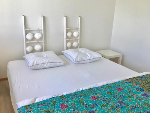 a bedroom with a bed with two pillows on it at Lakescape Zurich in Herrliberg