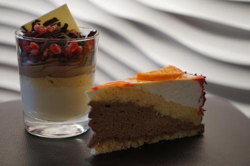 a piece of cake sitting next to a glass at Hotel Restaurant Sailer in Seewalchen
