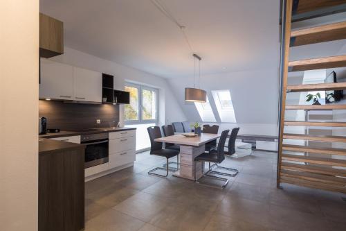 a kitchen and dining room with a table and chairs at Hotel Restaurant Sailer in Seewalchen
