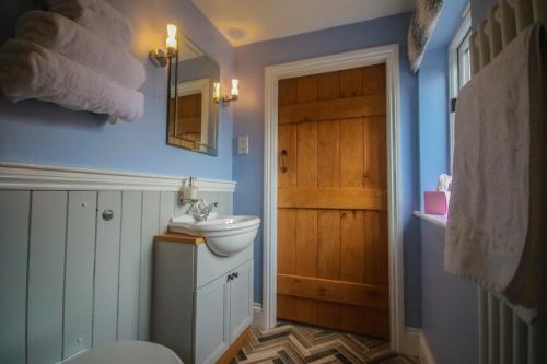 a bathroom with a toilet and a sink at The Little George in Eccleshall