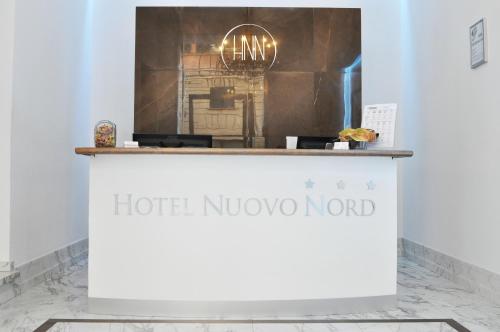 a white counter with a hotel noco nord sign on it at Hotel Nuovo Nord in Genova