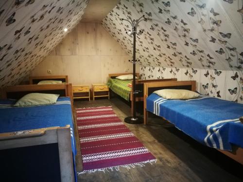 a room with two beds in a attic at Värava Farm in Pidula