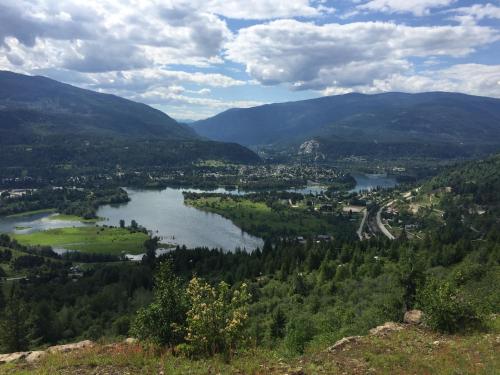 a view of a valley with a river and mountains at Canadas Best Value Inn & Suites-Castlegar in Castlegar