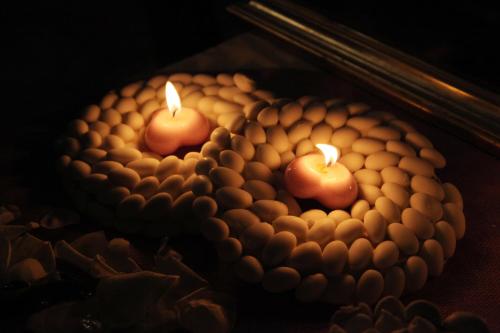 two lit candles sitting on top of a cake at Villa Morgana Resort and Spa in Torre Faro