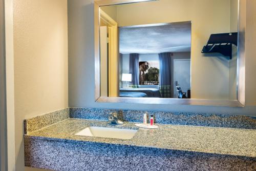 a bathroom counter with a sink and a mirror at Studio 6 Opelousas, LA in Opelousas