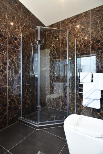 a bathroom with a shower and a toilet at 103 Prince of Bealey Motel in Christchurch