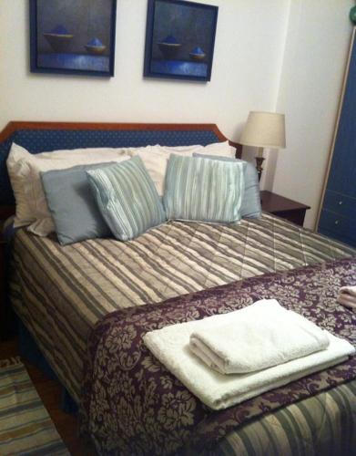 a bedroom with a bed with towels on it at Lisa House in Sintra