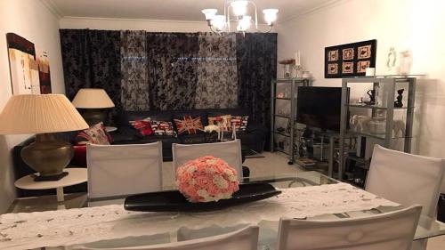 a dining room with a table and chairs and a living room at Lisa House in Sintra