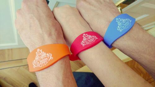 two arms with orange and blue bracelets on them at De Bedstee Boutique Capsules in Amsterdam
