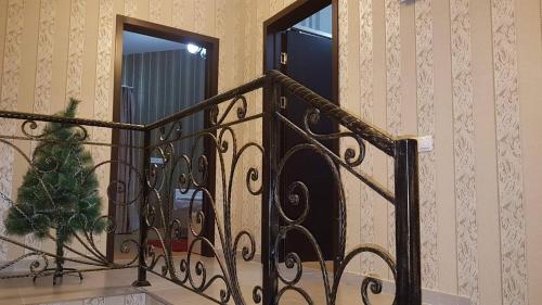 a stair railing with a christmas tree on it at villa in mountains in Bakuriani