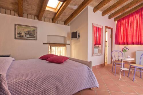 a bedroom with a bed and a table and chairs at B&B Corte Catalana in Marigliano