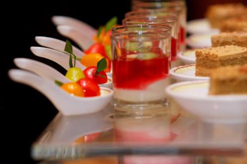 a table topped with plates of food on a table at The Grand Fourwings Convention Hotel Bangkok in Bangkok