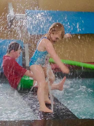 two young children playing in a water park at Toora Tourist Park in Toora