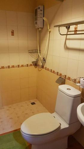 a bathroom with a toilet and a sink at Cha Am Perfect in Cha Am
