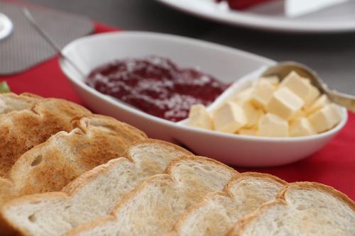 a plate with bread and butter and a bowl of jam at Misty Paradise of Lake Gregory in Nuwara Eliya