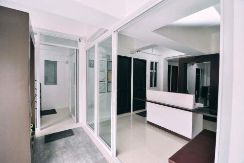 a room with white walls and glass partitions at The Strand Suites and Dormitel in Davao City