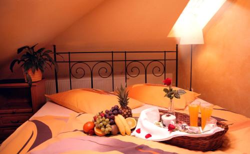 a tray of fruits and vegetables on a bed at Mahleruv Penzion Na Hradbach in Jihlava
