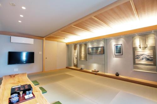 a large living room with a flat screen tv at Luxury Condo Shikine An Gion Shirakawa in Kyoto