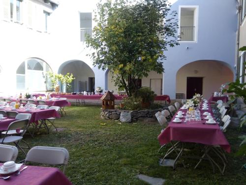 a group of tables and chairs in a yard at Le Prieuré in Saint-Dalmas-de-Tende