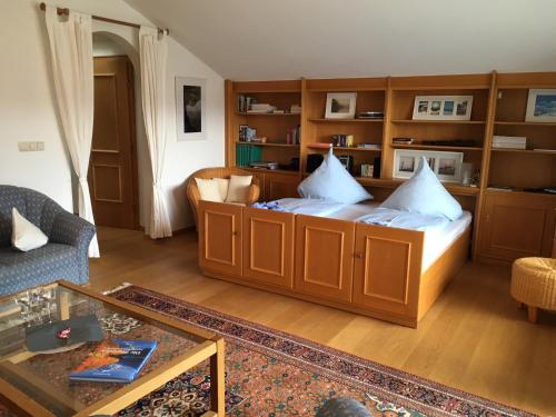 a living room with a bed with wooden cabinets at Marie-Anne in Garmisch-Partenkirchen