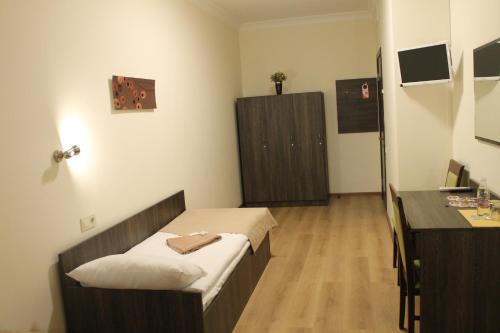 a hospital room with a bed and a desk at Non-stop Economy hotel in Boryspilʼ