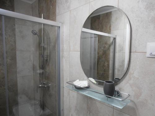 een badkamer met een douche en een spiegel bij Gothic House in Sibiu