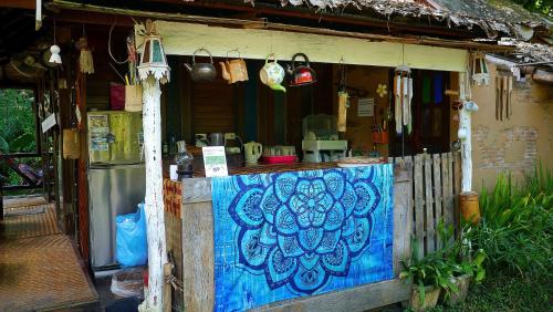 a house with a blue paint on the side of it at Pho Rak Nah Pai in Pai