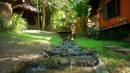 a small stream of water in front of a house at Pho Rak Nah Pai in Pai