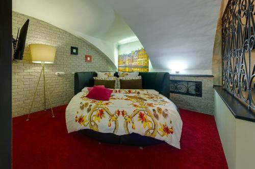 a bedroom with a bed and a red carpet at Apartment City in Saint Petersburg