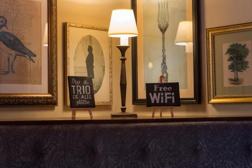 a shelf with two signs on top of it at Owl, Hambleton by Marston's Inns in Selby