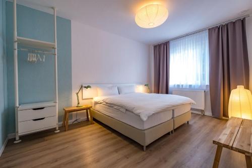 
a hotel room with a bed and a dresser at Hotel Cityroom in Gelsenkirchen
