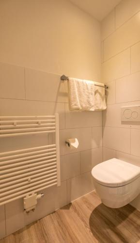 a bathroom with a toilet and a towel at Easy&cosy Cityroom in Gelsenkirchen