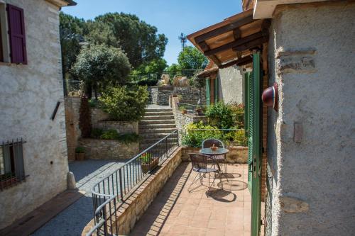 a balcony with a table and stairs in a building at Agriturismo Borghetto Il Montino in Rapolano Terme