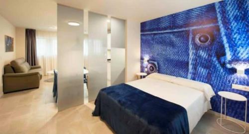 En eller flere senge i et værelse på Apartamentos Divan